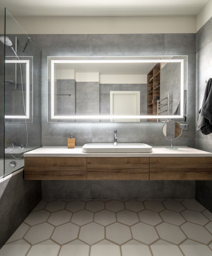 Badezimmer im skandinavischen Stil mit beleuchtetem Spiegel